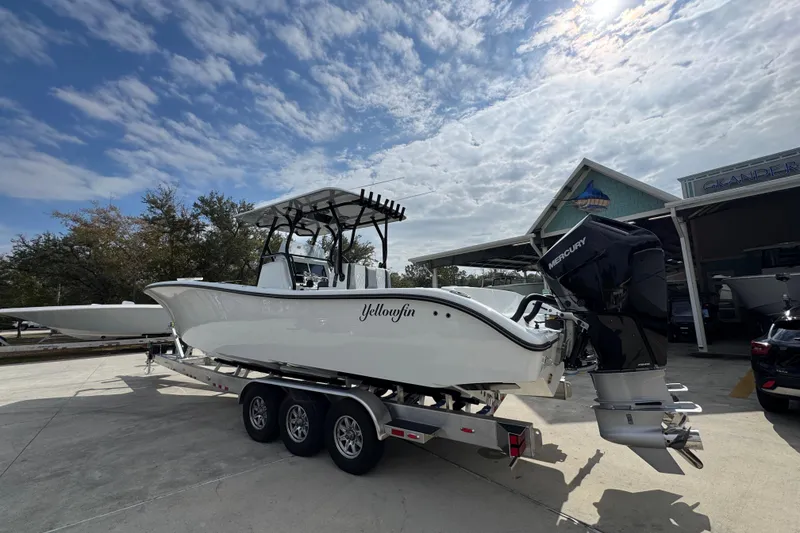 Slide: The Image of 2026 Yellowfin 34 Offshore boat on trailer under cloudy sky. - 19