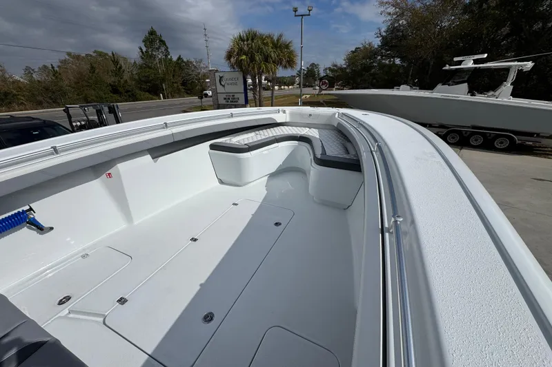 Slide: The Image of 2026 Yellowfin 34 Offshore boat with spacious deck and seating, parked outdoors. - 20