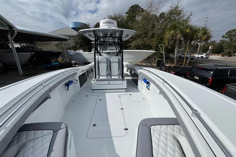 Slide: The Image of 2026 Yellowfin 34 Offshore boat interior with Garmin equipment, featuring spacious seating and modern design. - 25