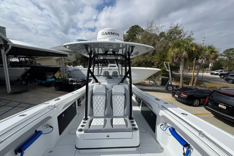 Slide: The Image of 2026 Yellowfin 34 Offshore boat with Garmin equipment, docked under cloudy skies. - 27