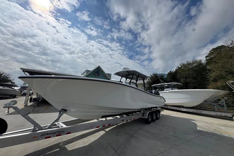 Slide: The Image of 2026 Yellowfin 34 Offshore boat on trailer under cloudy sky. - 3