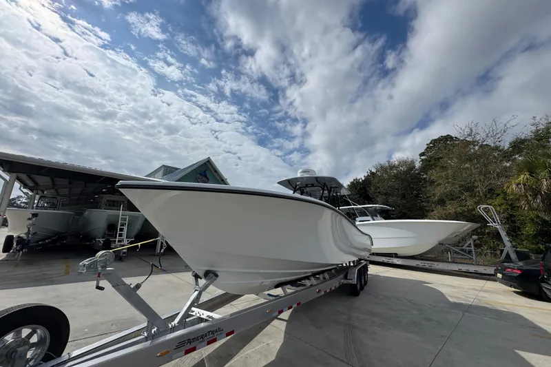 Slide: The Image of 2026 Yellowfin 34 Offshore boat on trailer under cloudy sky. - 4