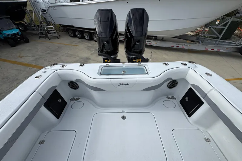Slide: The Image of 2026 Yellowfin 34 Offshore boat deck with dual outboard motors, spacious layout. - 49