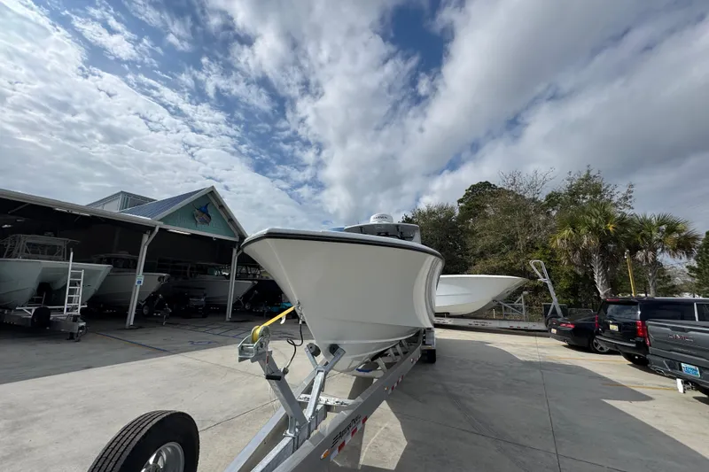 Slide: The Image of 2026 Yellowfin 34 Offshore boat on trailer under cloudy sky. - 5