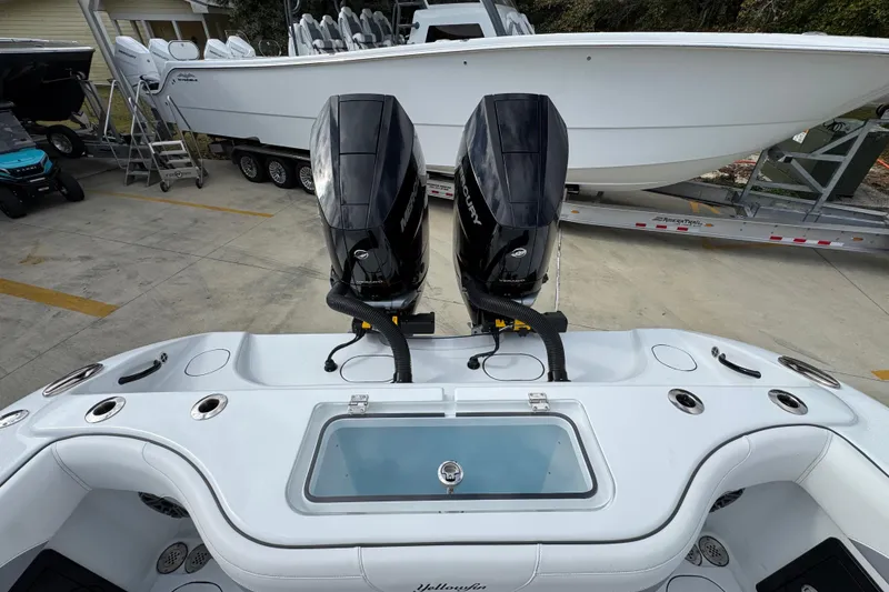 Slide: The Image of 2026 Yellowfin 34 Offshore boat with dual Mercury outboard engines, docked on a trailer. - 50