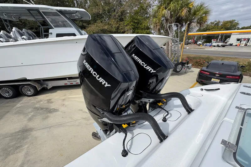 Slide: The Image of 2026 Yellowfin 34 Offshore with dual Mercury outboard engines, parked near a trailer and car. - 53