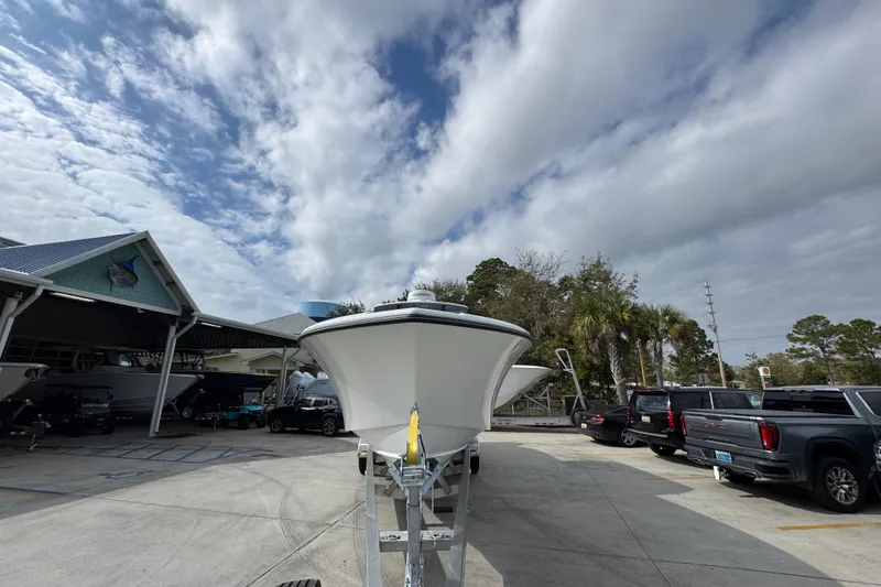 Slide: The Image of 2026 Yellowfin 34 Offshore boat on trailer at dealership under cloudy sky. - 6
