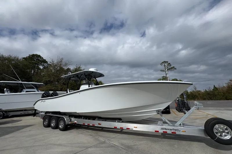 Slide: The Image of 2026 Yellowfin 34 Offshore boat on trailer under cloudy sky. - 9