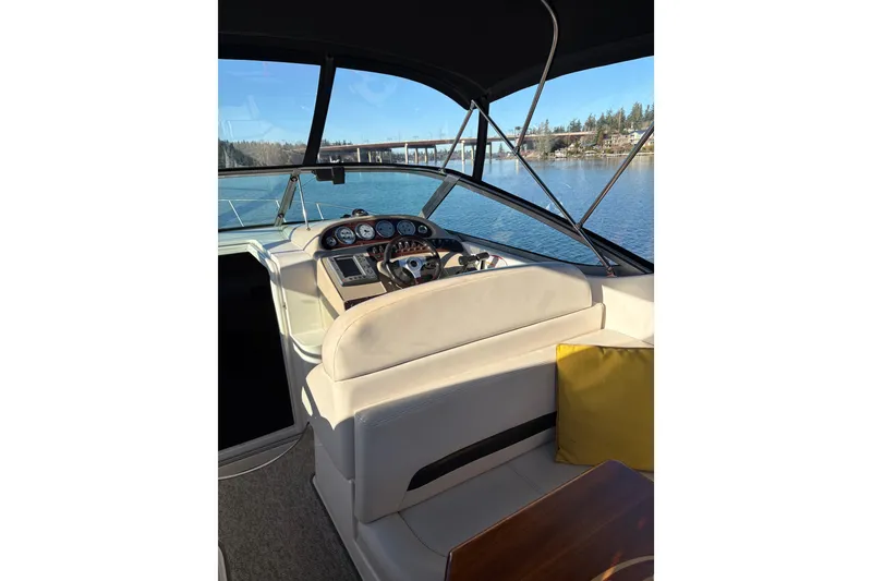 Slide: The Image of Interior of 2001 Chaparral Signature 300 boat with seating and table, overlooking water. - 14