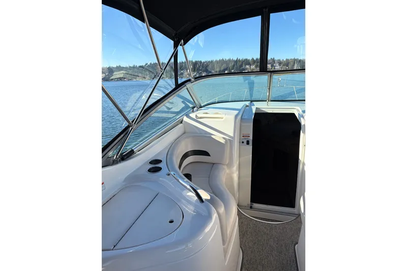 Slide: The Image of Interior of 2001 Chaparral Signature 300 boat with table and seating by the water. - 16