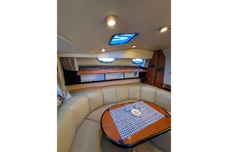 Slide: The Image of Interior of 2001 Chaparral Signature 300 boat with yellow cushions and scenic water view. - 19