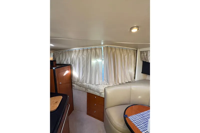 Slide: The Image of 2001 Chaparral Signature 300 cabin interior with cozy bed and dining area. - 21