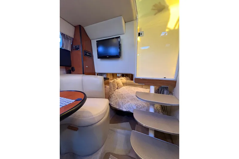Slide: The Image of 2001 Chaparral Signature 300 cabin interior with bed, skylight, and wooden cabinetry. - 23