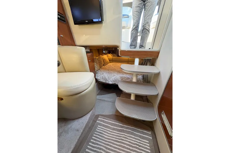 Slide: The Image of Interior of 2001 Chaparral Signature 300 boat with cozy seating and bed. - 24