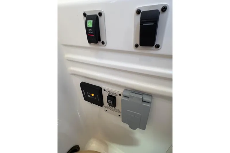 Slide: The Image of 2001 Chaparral Signature 300 boat head vent switch and speaker on white panel. - 35