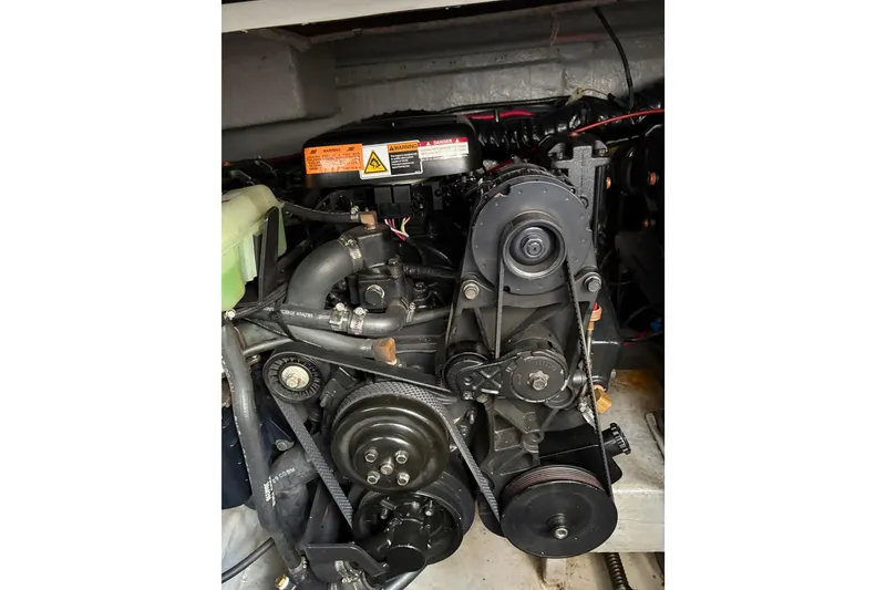 Slide: The Image of Engine of 2001 Chaparral Signature 300 boat, showcasing belts and components. - 38