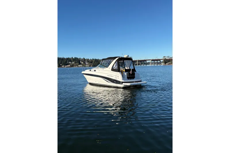 Slide: The Image of 2001 Chaparral Signature 300 boat on calm water under clear blue sky. - 4