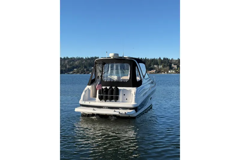 Slide: The Image of 2001 Chaparral Signature 300 boat on calm water under clear blue sky. - 5