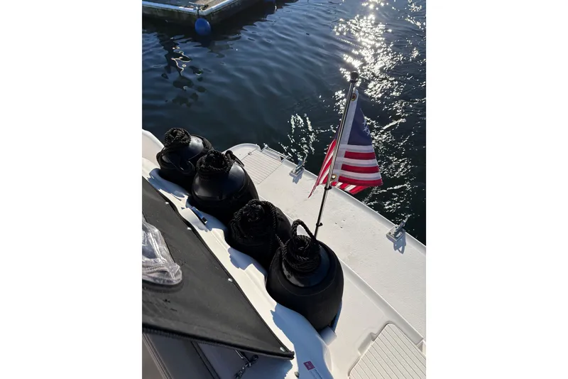 Slide: The Image of 2001 Chaparral Signature 300 boat on calm water, rear view with clear sky. - 6