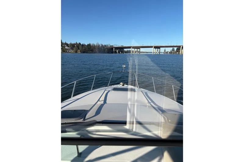 Slide: The Image of 2001 Chaparral Signature 300 boat with American flag and dock fenders on deck. - 7