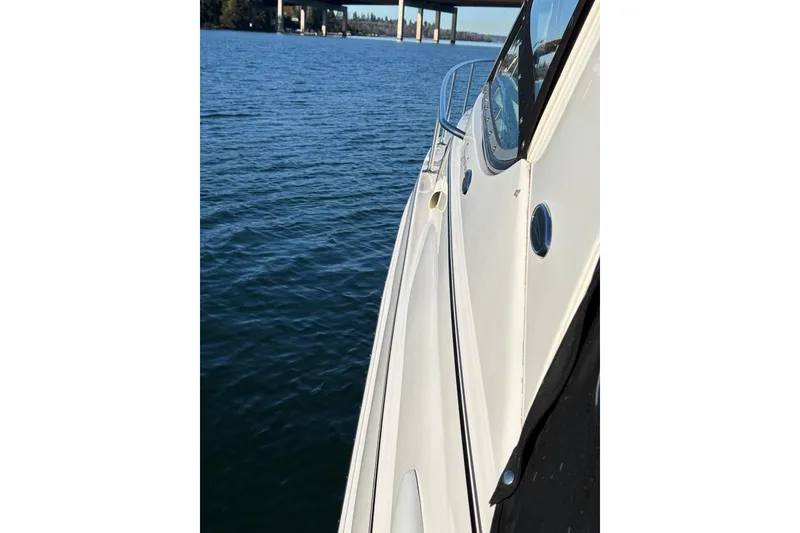 Slide: The Image of 2001 Chaparral Signature 300 boat cruising on a sunny day near a bridge. - 8
