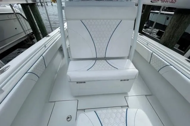 Slide: The Image of 2023 Contender 28 Tournament boat interior with white cushioned seating and hexagonal pattern. - 10