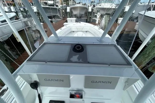 Slide: The Image of 2023 Contender 28 Tournament boat with Garmin electronics at a marina dock. - 13
