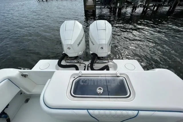 Slide: The Image of 2023 Contender 28 Tournament boat with dual Mercury engines on the water. - 15
