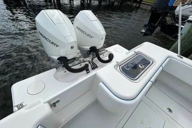 Slide: The Image of 2023 Contender 28 Tournament boat with dual Mercury engines, docked by the water. - 18