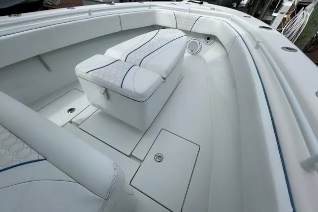 Slide: The Image of 2023 Contender 28 Tournament boat interior with cushioned seating and storage compartments. - 20