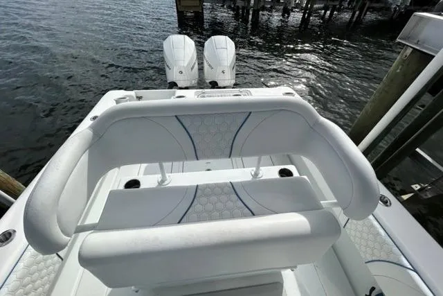 Slide: The Image of 2023 Contender 28 Tournament boat with dual engines, docked by the water. - 23