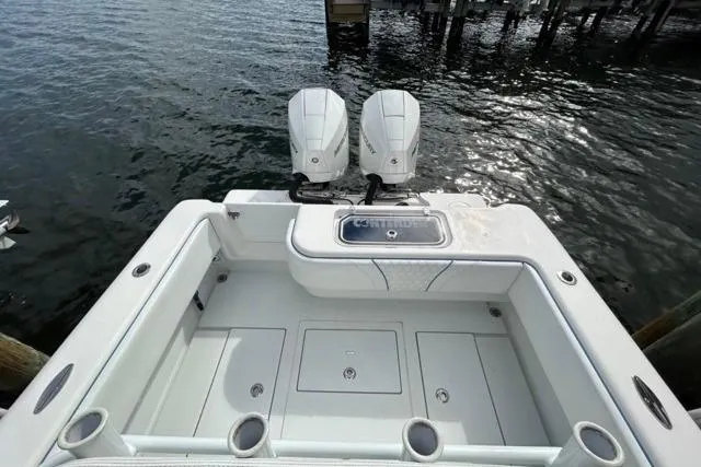 Slide: The Image of 2023 Contender 28 Tournament boat with dual outboard motors, docked on water. - 25