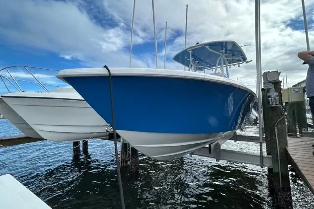 Slide: The Image of 2023 Contender 28 Tournament boat docked, featuring a sleek blue hull design. - 29