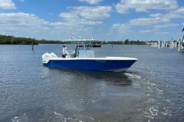 Slide: The Image of 2023 Contender 28 Tournament boat cruising on a sunny day in open water. - 31