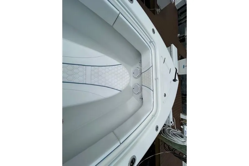 Slide: The Image of 2023 Contender 28 Tournament boat interior with sleek white seating and deck design. - 8
