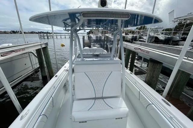 Slide: The Image of 2023 Contender 28 Tournament boat docked at marina, showcasing sleek design and spacious seating. - 9
