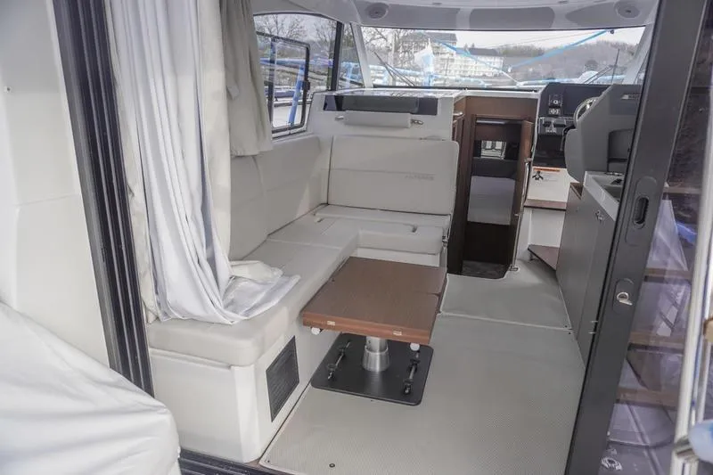 Slide: The Image of Interior storage of 2026 Beneteau Antares 11 Fly, featuring open cabinets and a small refrigerator. - 14