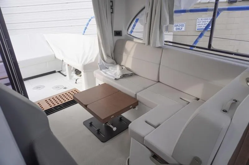 Slide: The Image of Interior of 2026 Beneteau Antares 11 Fly with open overhead storage and modern lighting. - 15
