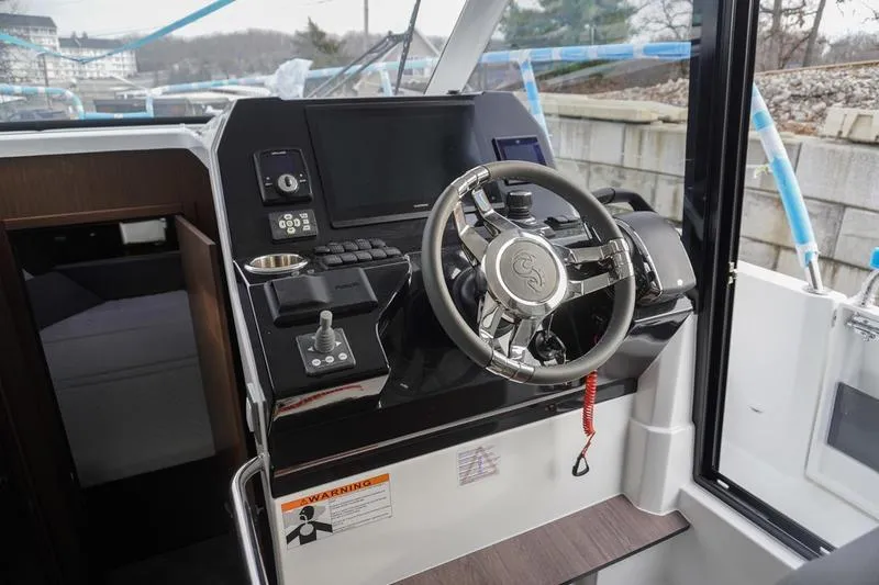 Slide: The Image of 2026 Beneteau Antares 11 Fly helm with modern controls and navigation display. - 18