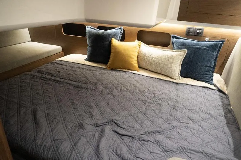 Slide: The Image of Cozy cabin interior of 2026 Beneteau Antares 11 Fly with plush bedding and cushions. - 23