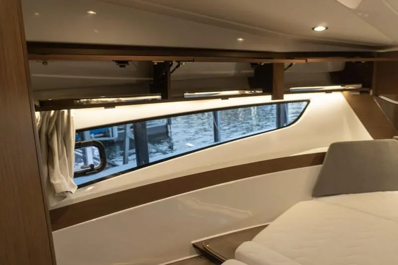 Slide: The Image of Interior cabin of 2026 Beneteau Antares 11 Fly, featuring modern design and large window. - 30