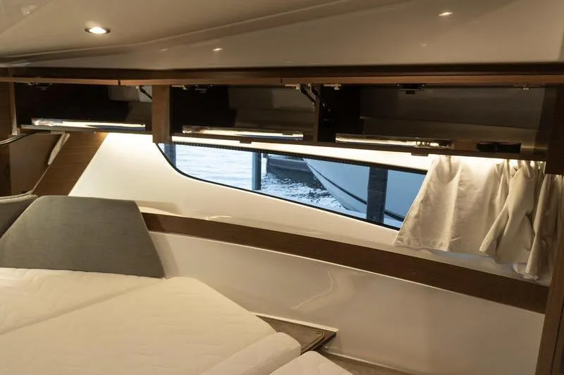 Slide: The Image of Interior cabin of 2026 Beneteau Antares 11 Fly, featuring modern design and window view. - 31