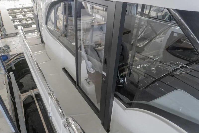 Slide: The Image of 2026 Beneteau Antares 11 Fly yacht with sleek glass sliding door in marina. - 34