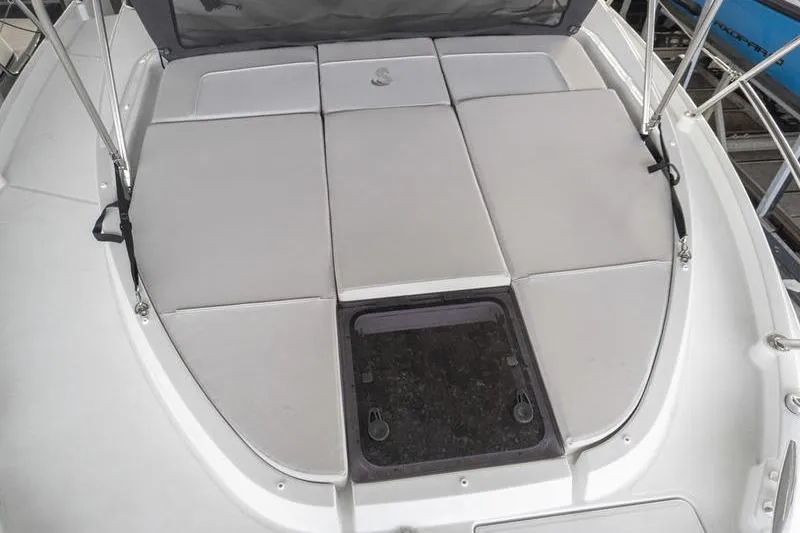 Slide: The Image of 2026 Beneteau Antares 11 Fly boat deck with cushioned seating and storage hatch. - 36