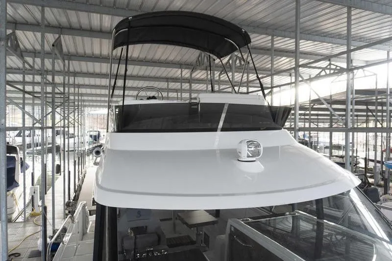 Slide: The Image of 2026 Beneteau Antares 11 Fly yacht in covered marina, showcasing sleek design and flybridge. - 37