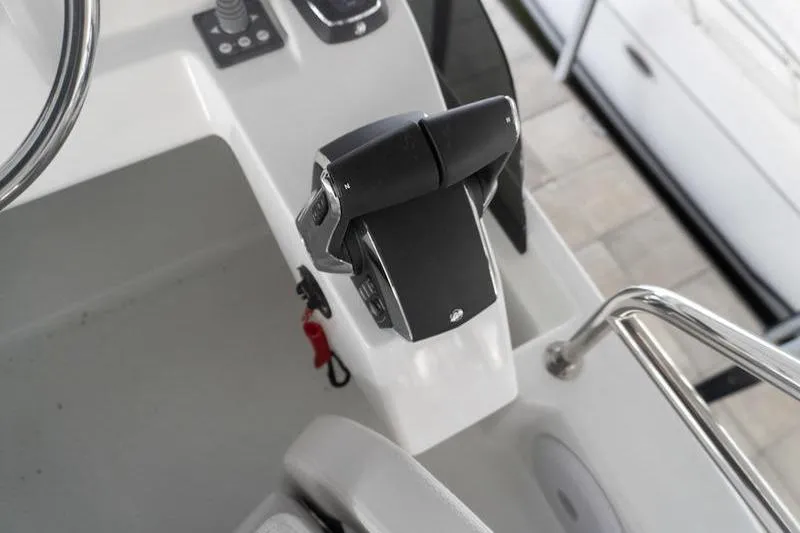 Slide: The Image of Control panel of 2026 Beneteau Antares 11 Fly boat, featuring throttle and steering wheel. - 45