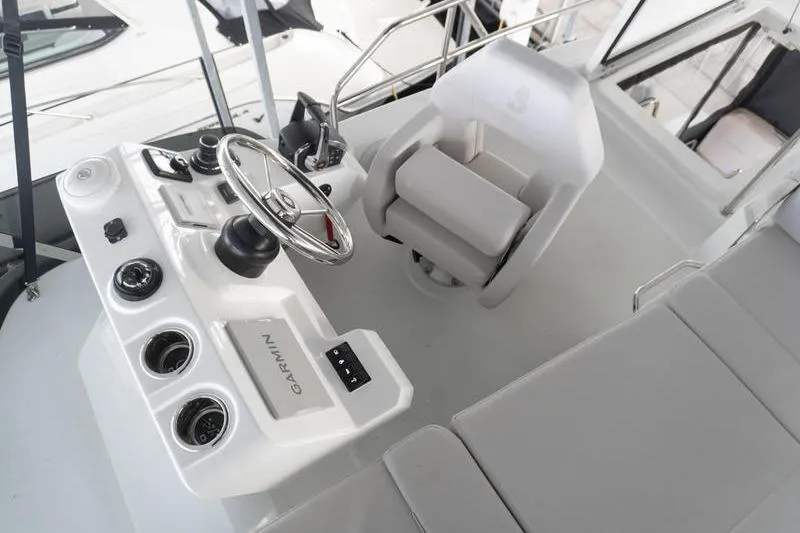 Slide: The Image of 2026 Beneteau Antares 11 Flybridge helm with Garmin navigation system and comfortable seating. - 47