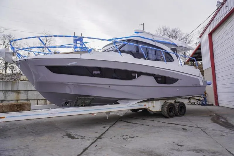 Slide: The Image of Interior of 2026 Beneteau Antares 11 Fly with modern seating and tables. - 6
