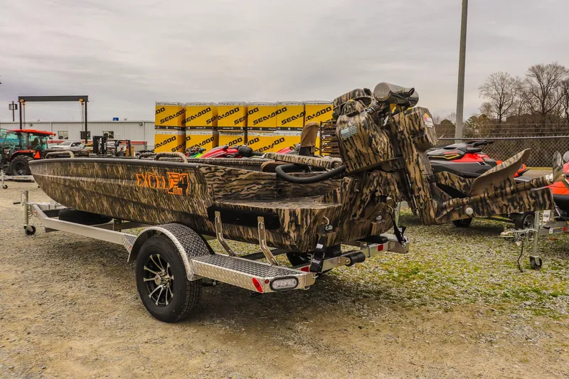 Slide: The Image of 2026 Excel 1751 Shallow Water F4 boat on trailer, camo design, outdoor display. - 2
