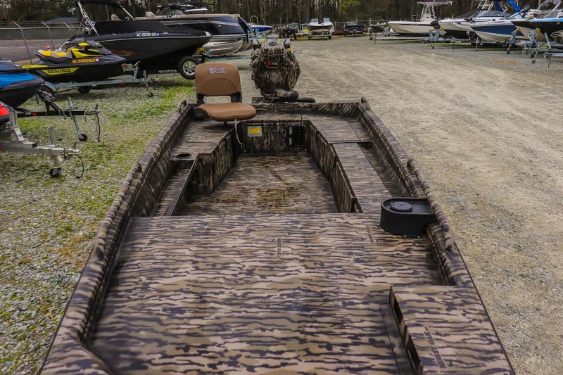 Slide: The Image of 2026 Excel 1751 Shallow Water F4 boat with camouflage design in a boatyard. - 7